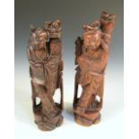 A pair of carved wooden figures of the Hehe Erxian, each wire inlaid figure standing holding up