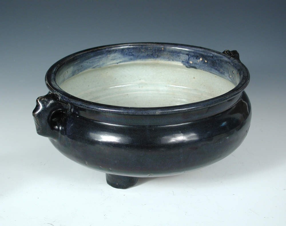 An aubergine glazed censer bowl, period of Kangxi, two lug handles below a broad rim, the