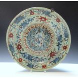 A 17th/18th century Swatow style dish painted in red and green over underglaze blue with precious