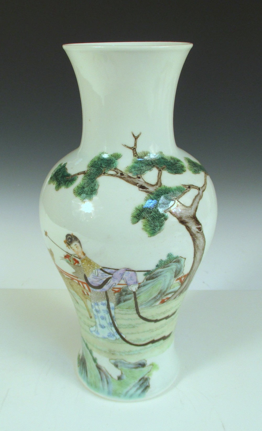 A Republic Period baluster vase painted with a lady harvesting lingzhi growing amongst rocks below a
