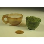 A spinach green jade and a grey agate cup, the first with grey speckling, 5cm (2 in) diameter, the