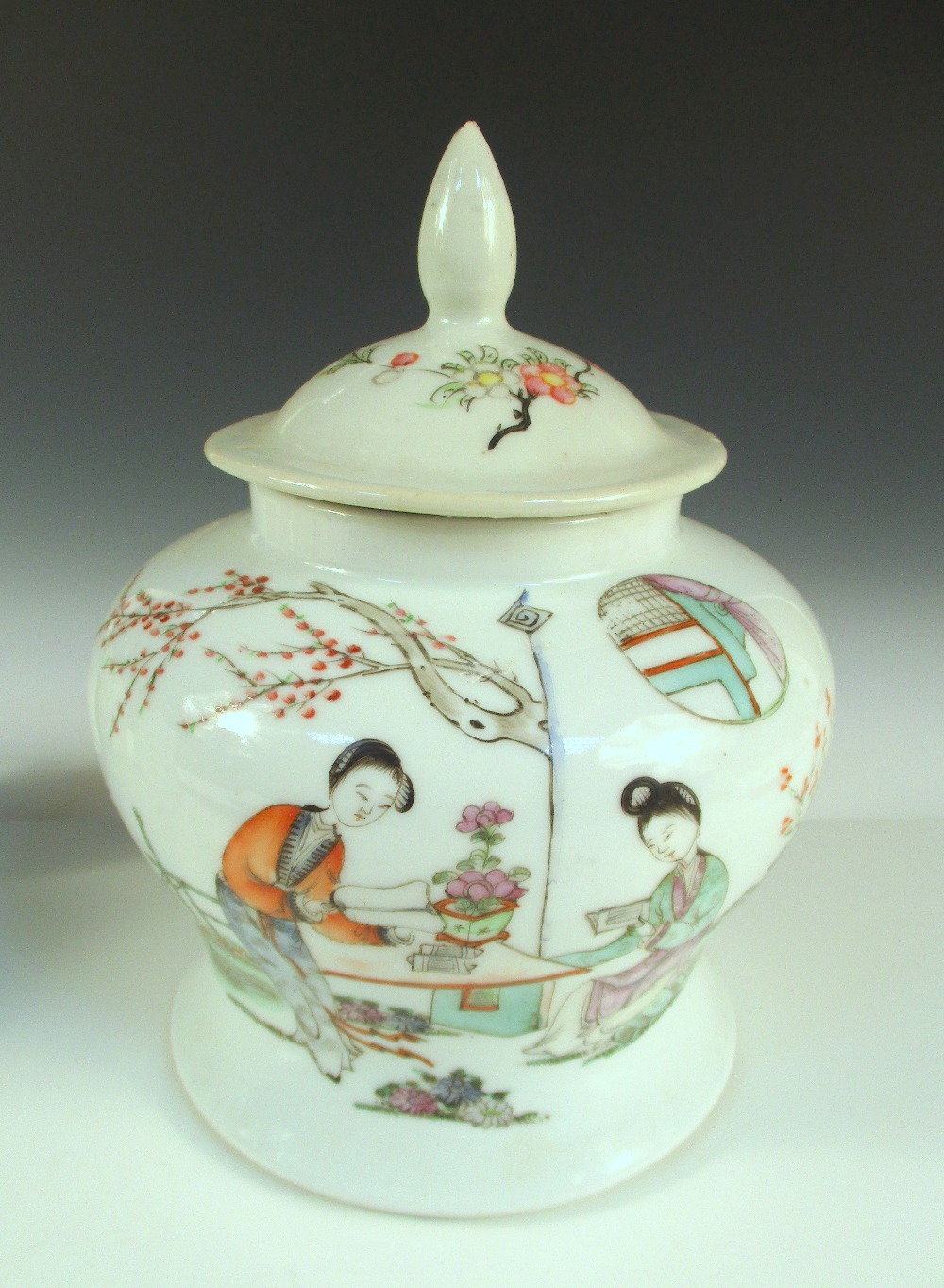 A Republic Period famille rose baluster jar and cover painted on one side with two ladies reading by