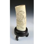 An early 20th century ivory tusk on wooden stand pierced and carved overall pairs of figures going