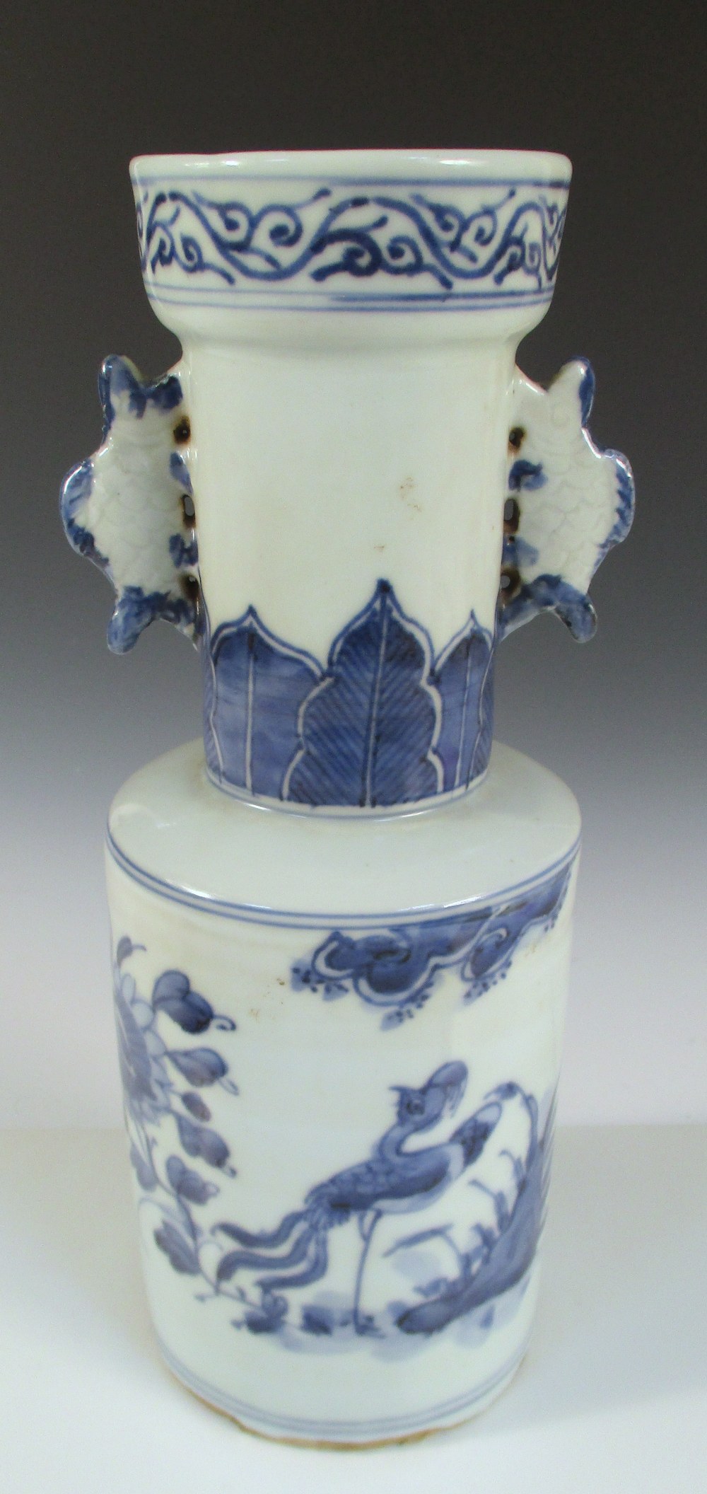A blue and white vase, fish handles applied to the cylindrical neck below a broad rim painted with