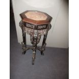 A 19th century marble inset hardwood stand, the octagonal top with beaded edge, the apron pierced