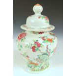 An early 20th century famille rose jar and cover, the sides of the baluster shape painted with a