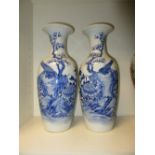 A pair of late 19th/early 20th century blue and white vases, magnolia flowering on the waisted