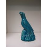 A 19th century turquoise glazed bird perched on a rock, the glaze with a fine crackle, a seal mark