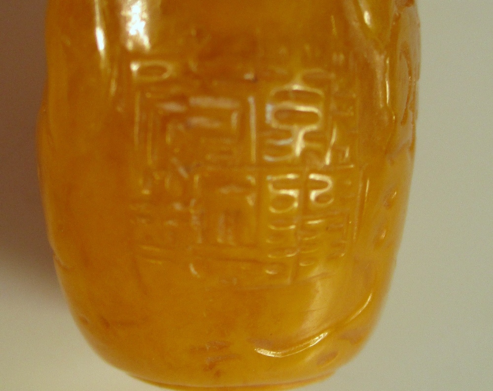 Two moulded glass snuff bottles and a stopper, the flattened bottle shape of the amber example - Image 6 of 6