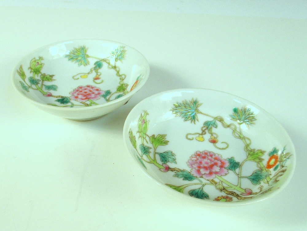 A pair of small saucers, six character marks of Guangxu in red, each with central pink peony bloom