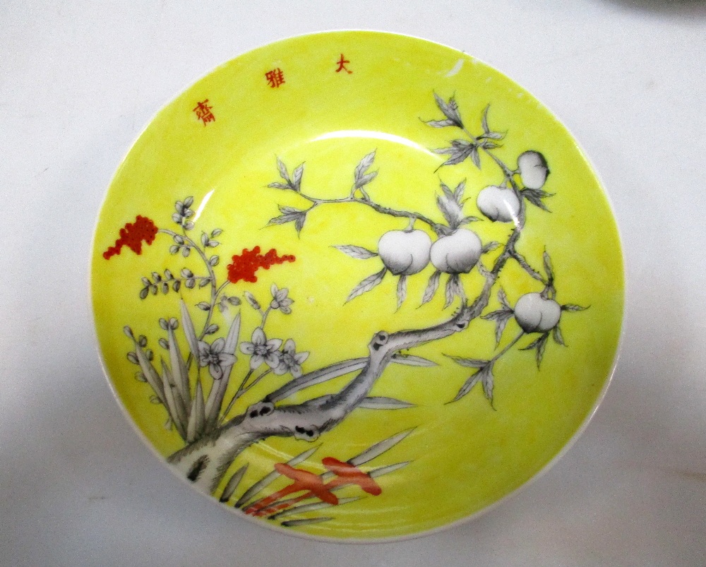 A pair of yellow ground saucers painted in grey with peaches, the heads of the millet and three - Image 2 of 5
