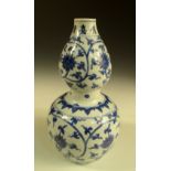 A Jiajing marked blue and white gourd shaped vase, the six character marks below the rim above two