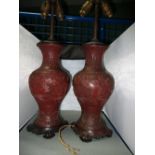 A pair of 19th century cinnabar lacquer vases as lamps, the baluster bodies with figures in mountain