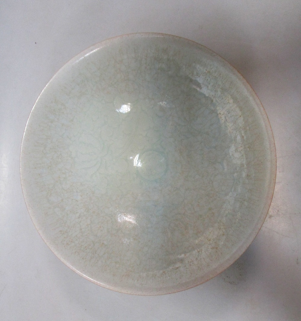 A Qingbai bowl, the misty blue glaze with a slight crackle over incised lotus scrolling on the - Image 2 of 3