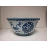 A Chinese provincial blue and white bowl, the exterior painted with floral roundels alternating with