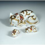 A graded set of three Kutani sleeping cats, the fur with gilt markings, their necks with bells