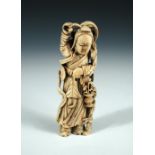 A 19th century ivory figure of an immortal holding a sacred pearl in his right hand up above his