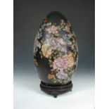 A 20th century cloisonne egg shaped ornament on wood stand, 51cm (21 in) high (2) There are some