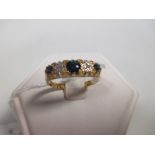 An 18ct five stone sapphire and diamond ring, the three dark blue sapphire interspaced with round