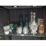 A quantity of coloured and cut glass decanters and drinking glasses