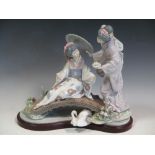 A Lladro figure of two Gheisha girls on a bridge, 34 cm wide