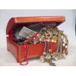 A tooled leather casket containing a quantity of assorted costume jewellery, compacts, coins,