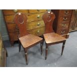 A pair of 19th century mahogany hall chairs