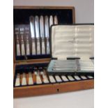A 1930's plated cased butter knife set and a part knife and fork set