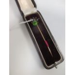 A green hardstone and split pearl fly stick pin set in unmarked yellow metal, cased