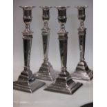 Four silver plated candlesticks
