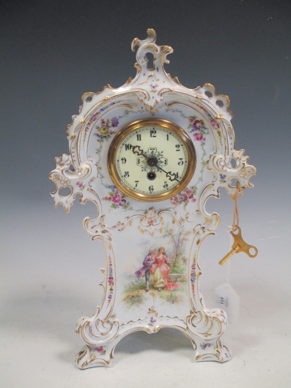 A Dresden floral decorated mantle clock, 34cm high, in working order with key