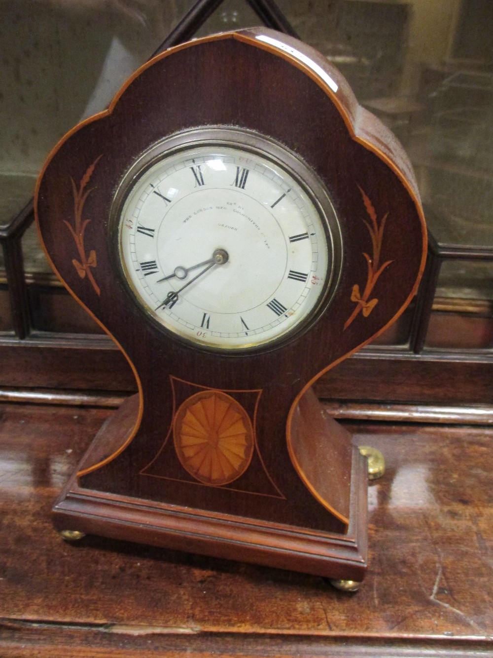 An Edwardian mantel clock with inlaid decoration