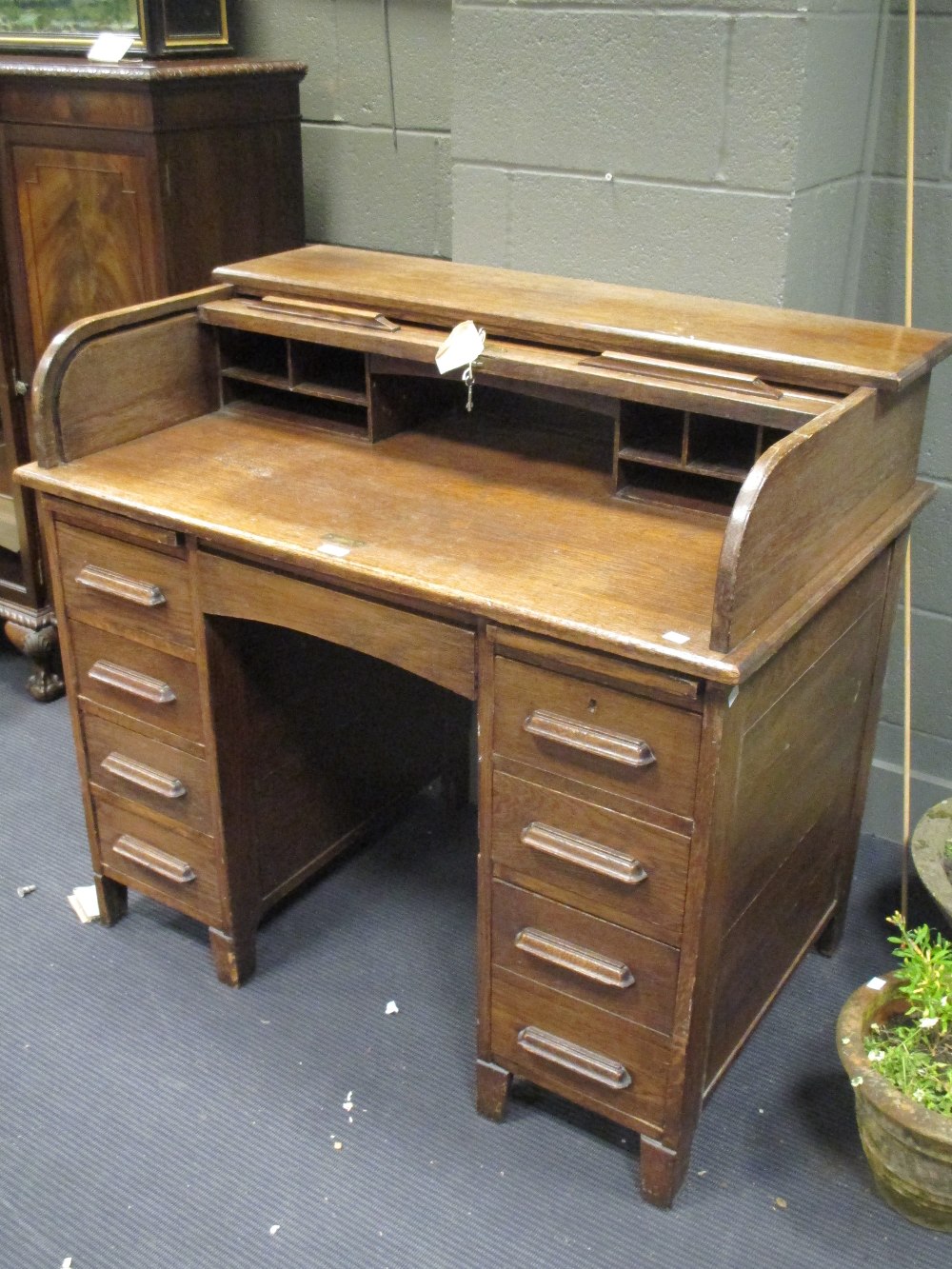 A small oak roll top pedestal desk with six drawers, 107cm wide
