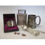 A silver christening jug, five silver coffee spoons and a christening fork, together with a napkin