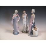 Three Lladro figures of elegant ladies, tallest 34cm