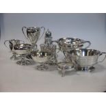 Two silver porringers, four small silver trophy cups, a silver salt, pepper and mustard, approx.