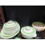 A Clarice Cliff Staffordshire pottery part dinner service in green and cream and a Clarice Cliff