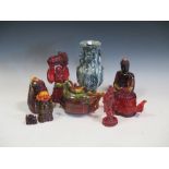 A collection of Oriental faux amber moulded teapots and figures and a carved two-handled vase