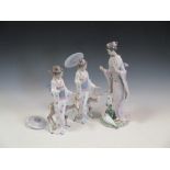 A Lladro Gheisha girl standing with two storks, 40 cm high together with two Lladro Gheisha girls