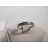 A diamond half hoop ring, the round brilliant cut diamonds channel set in white precious metal,