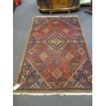 A Persian red ground rug, 144 x 240cm