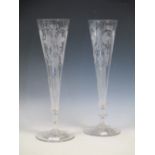 A pair of large late 19th century glass trumpet vases with engraved decoration, one damaged