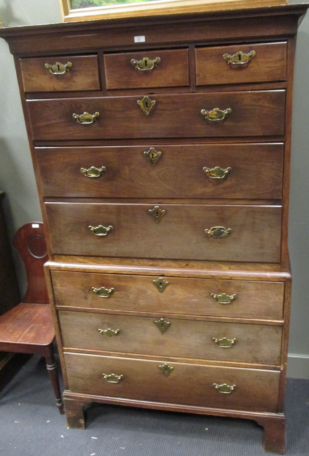 A George III mahogany chest on chest, the upper part with cavetto cornice, fitted three short and