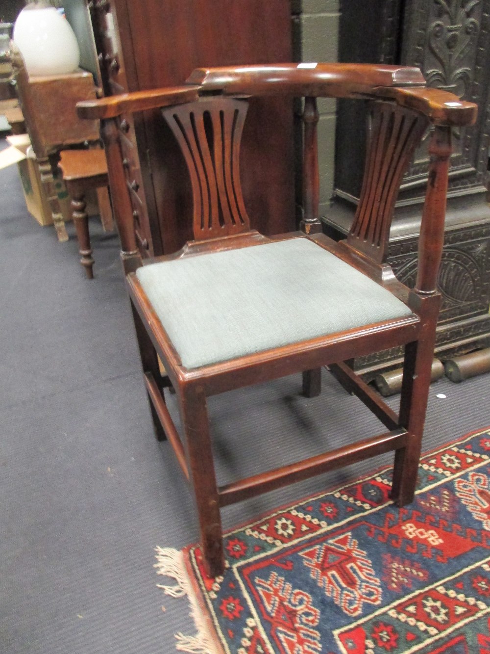 A George III yew wood corner chair