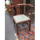 A George III yew wood corner chair