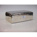 A silver cigarette box by William Comyns, London 1900, of plain rectangular shape, 20.5cm wide, a/f