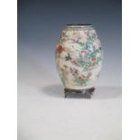 A satsuma vase decorated with flowers and a bird, signed