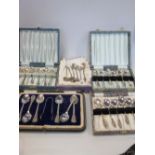 Silver teaspoons and tongs, cased and four other sets of teaspoons (5)