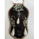 A paste and faux pearl pair of earrings and matching pendant/brooch, each comprising a paste set