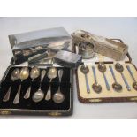 A quantity of silver to include a silver cigarette box, matchbox cover, enamelled coffee spoons, a